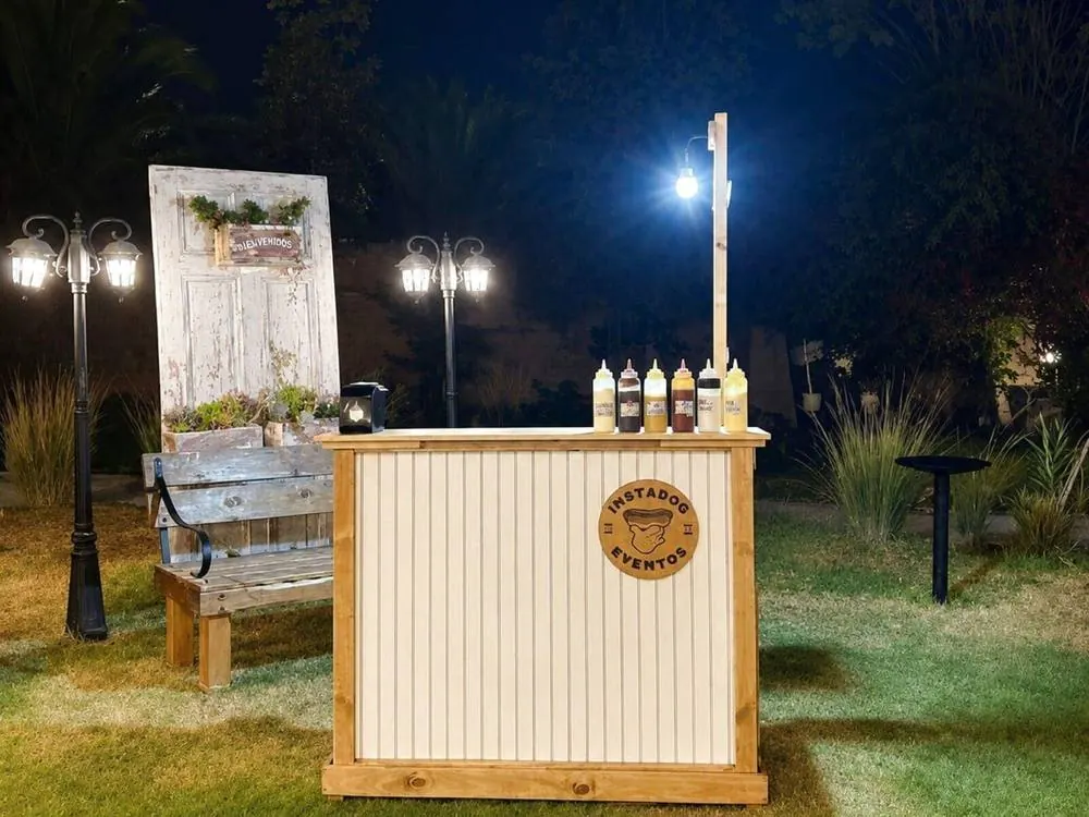 Carro de comida Instadog iluminado en un evento nocturno